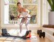 a woman doing a bowflex workout at home