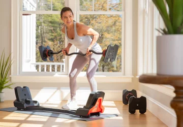 a woman doing a bowflex workout at home