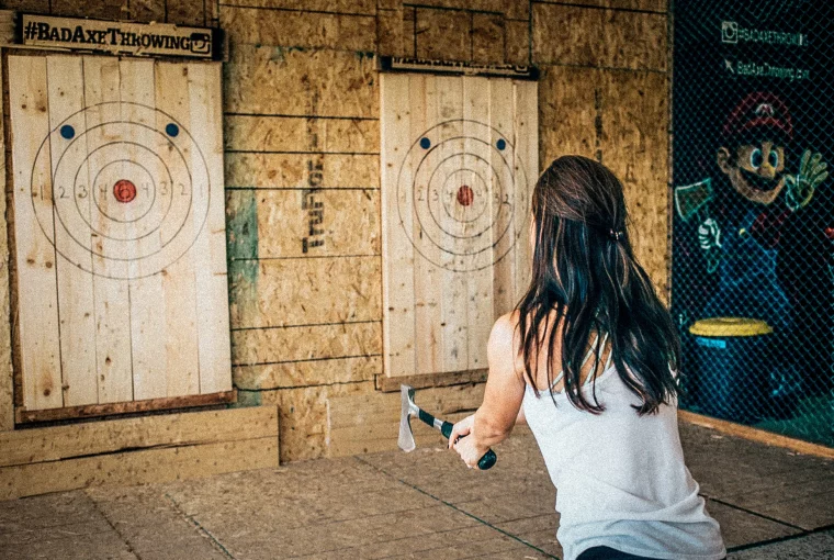 a woman throwing an axe