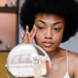 a woman putting on moisturizer