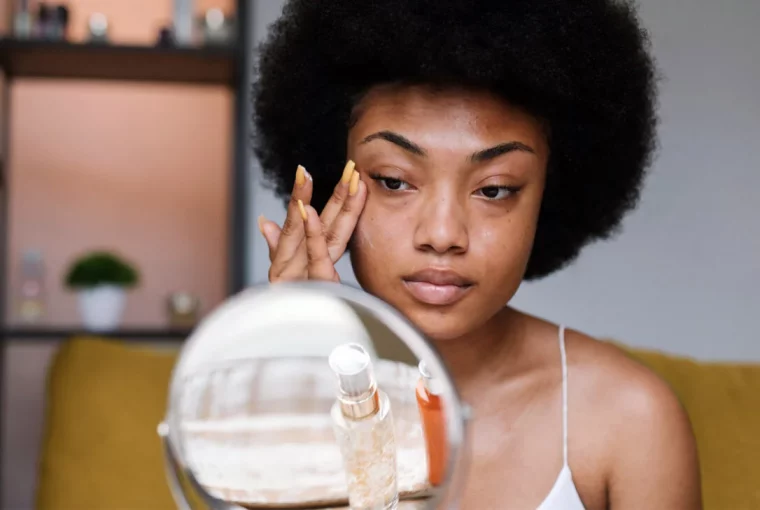 a woman putting on moisturizer