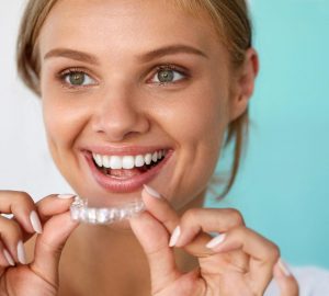 Smiling Woman With Beautiful Smile Using Teeth Whitening Tray. High Resolution Image