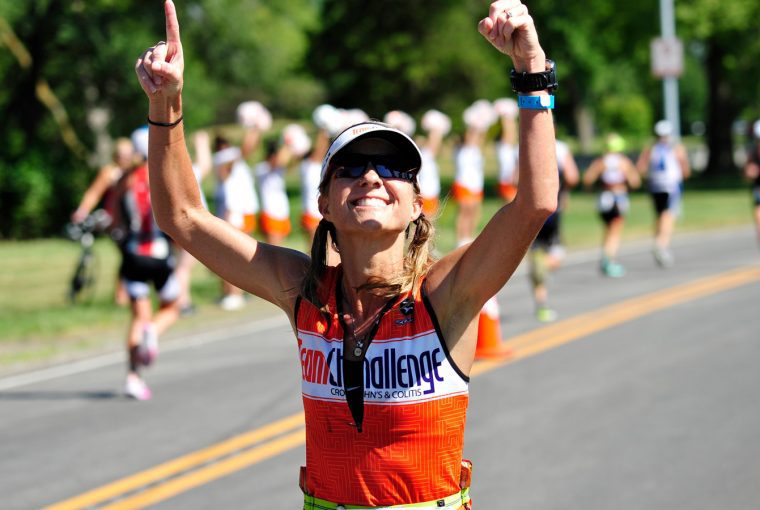 a woman in the foreground of a road race
