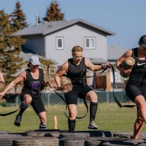 a group of athletes running an obstacle course race