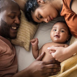 a family cuddling their baby