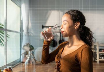 a woman drinking a bottle of water