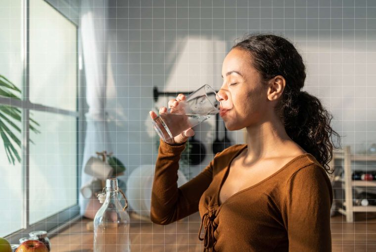 a woman drinking a bottle of water