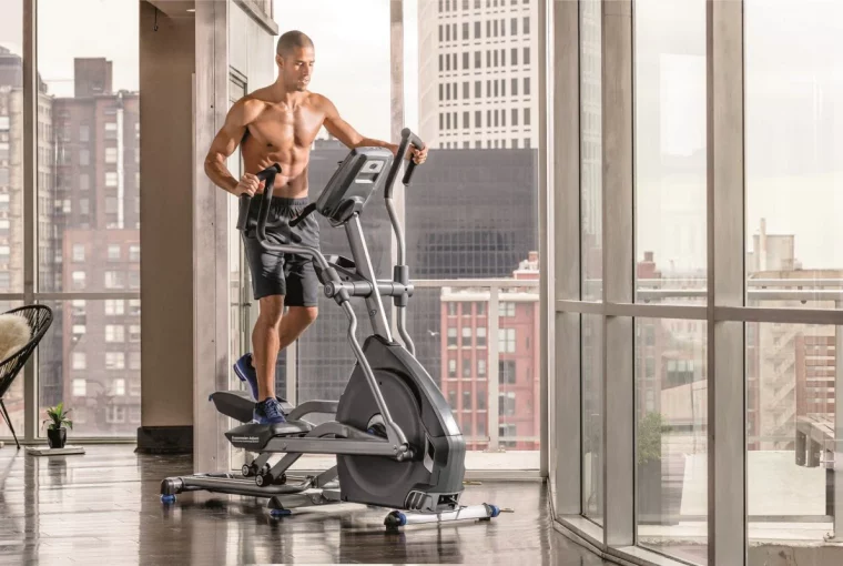 a man in his office running on an elliptical