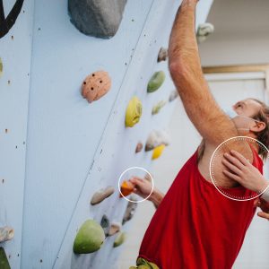a man getting some support slimbing a wall