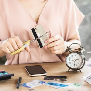 a woman cutting their crediot card