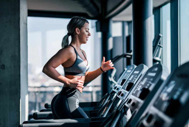 a woman running on a treadmill