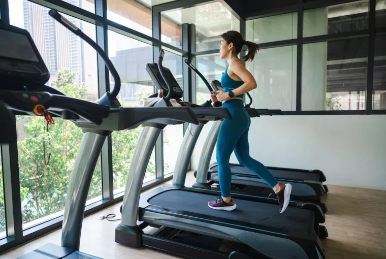 a woman running on a treadmill