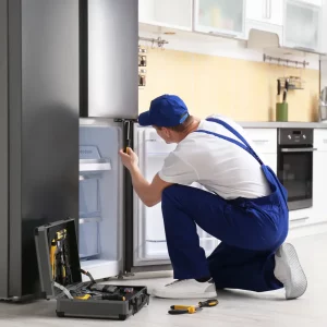 a man fixing a fridge