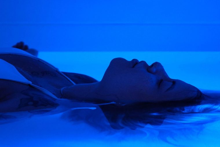 a person laying in a float tank