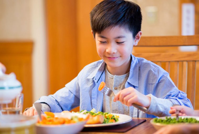 a boy eating a healthy meal