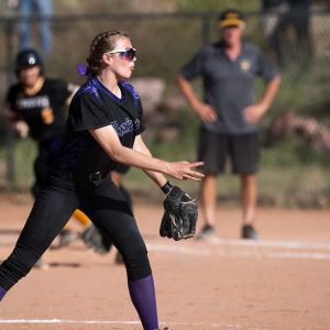 a woman throwing a softball
