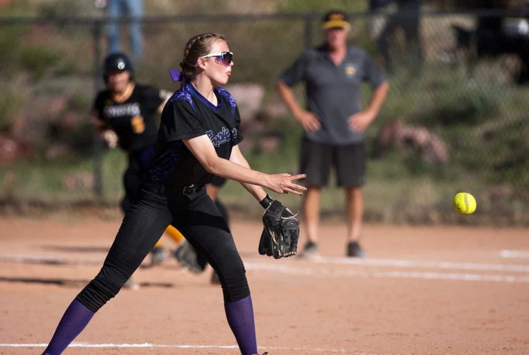 a woman throwing a softball