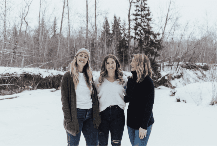 a group of women outside in a snowy winter scene