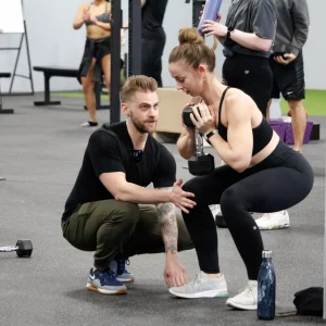 a trainer working with a female client
