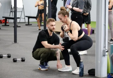 a trainer working with a female client