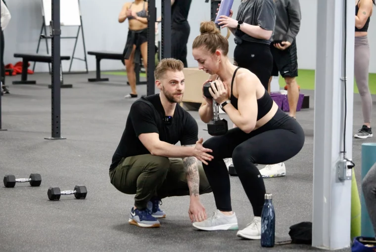 a trainer working with a female client