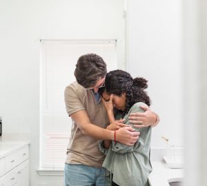 a couple embracing while crying