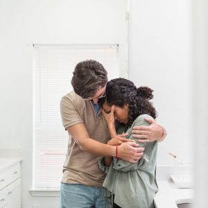 a couple embracing while crying