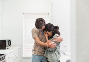 a couple embracing while crying