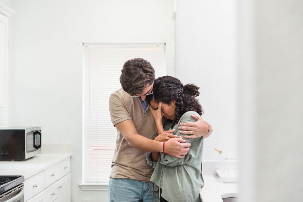 a couple embracing while crying
