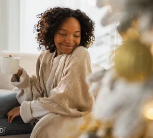 a woman in a creat sweater smiling