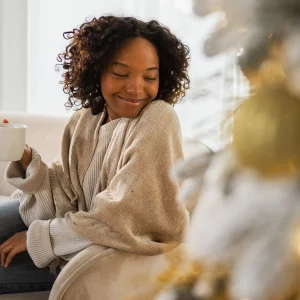 a woman in a creat sweater smiling