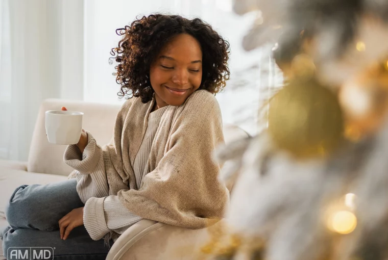a woman in a creat sweater smiling