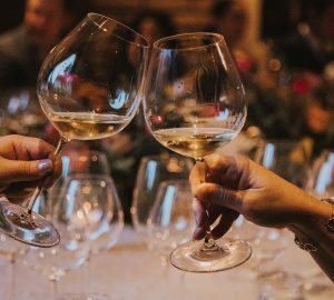 a pair cheersing at a holiday party