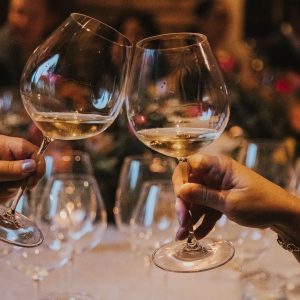 a pair cheersing at a holiday party