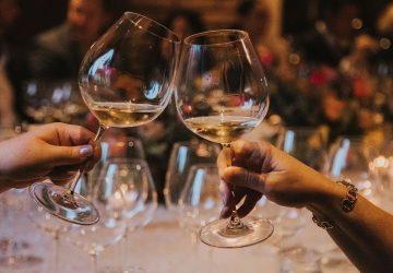 a pair cheersing at a holiday party