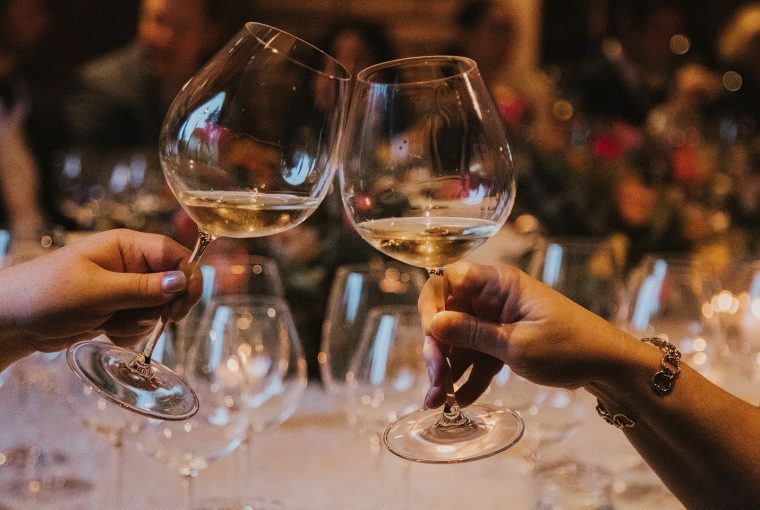 a pair cheersing at a holiday party