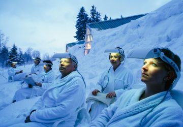 a group of people with lights on their foreheads