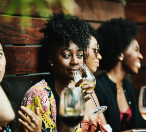 a group of young people drinking wine