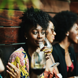 a group of young people drinking wine