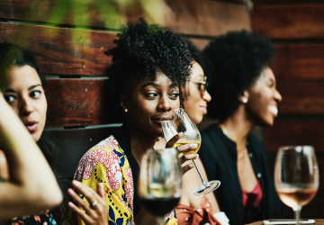 a group of young people drinking wine