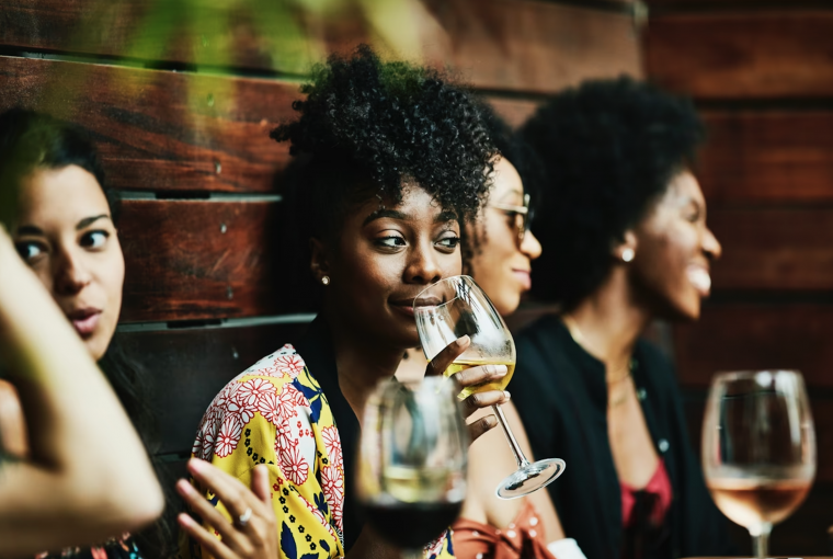 a group of young people drinking wine