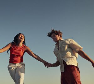 a smiling couple holding hands