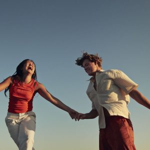 a smiling couple holding hands