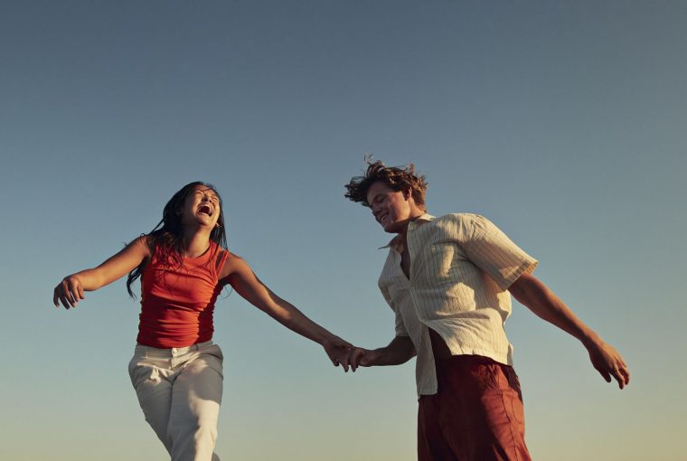 a smiling couple holding hands