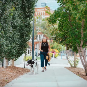 a woman walking with her dog