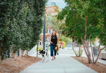 a woman walking with her dog
