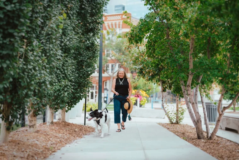 a woman walking with her dog