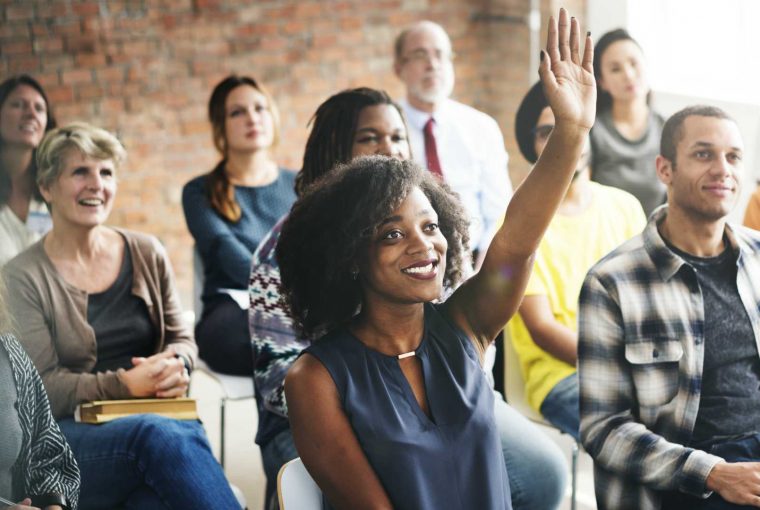 a group of adults in a classroom