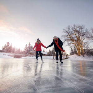 a couple skating outdoors in a winter setting