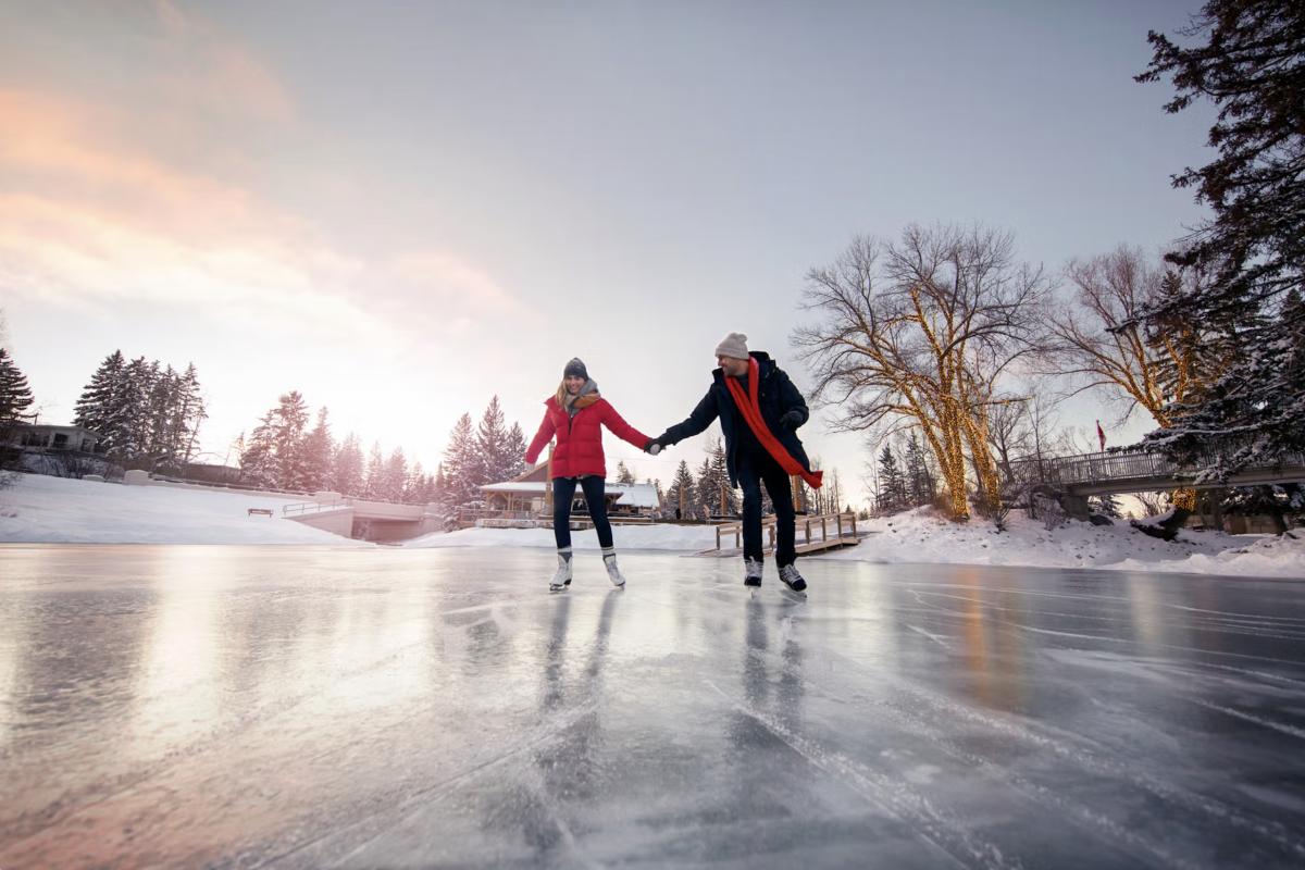 a couple skating outdoors in a winter setting